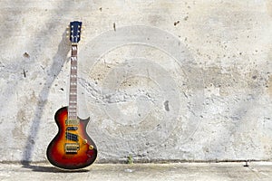 Electric guitar in front of a vintage wall