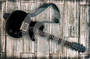 Electric guitar grunge look studio shot up view on wooden background