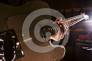 Electric guitar in guitarist hands closeup