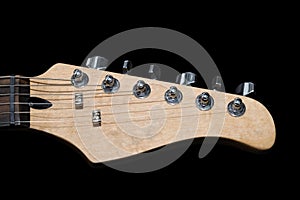 Electric guitar headstock isolated on black