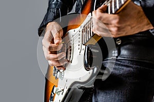 Electric guitar. Man playing guitar. Closeup hand playing guitar