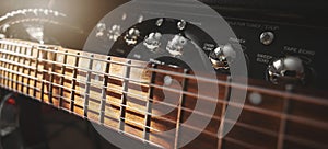 electric guitar neck and amplifier closeup in sound recording studio. rock music background