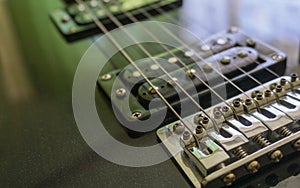 Electric guitar part close-up. Neck and humbucker pickup. Horizontal composition. Studio shot.