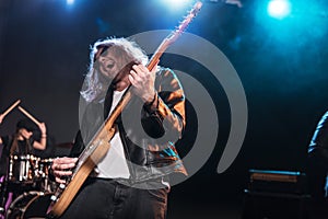 Electric guitar player with rock and roll band performing hard rock music