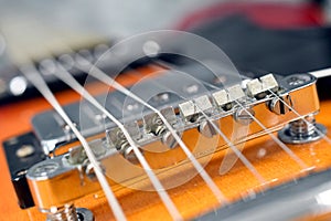 Electric guitar strings close up of bridge