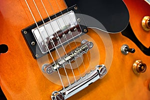 Electric guitar strings close up of bridge and humbucker pickup