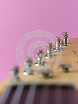 electric guitar tuners isolated pink background