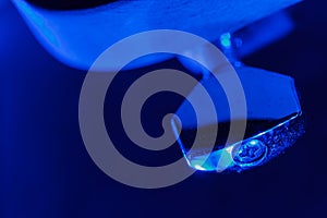 Electric guitar tuning pegs in blue light