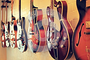 Electric guitars body aligned on wall