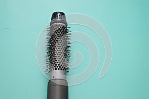 Electric hair dryer with a round brush. Coiled hair after drying. Hair loss. Rotating hair brush, styler, barber tool