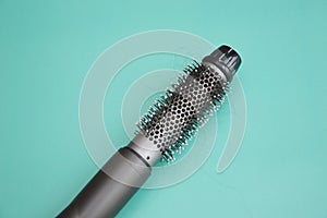 Electric hair dryer with a round brush. Coiled hair after drying. Hair loss. Rotating hair brush, styler, barber tool