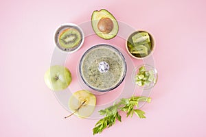 Electric hand blender with fruits and ready smoothies on a pink background. Flat lay