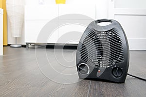 Electric heater on laminate floor in the room