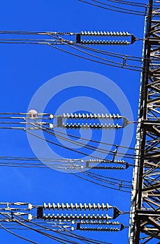 Electric high voltage pillar. Closeup of insulators. Sky background