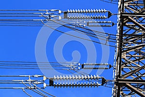 Electric high voltage pillar. Closeup of insulators. Sky background