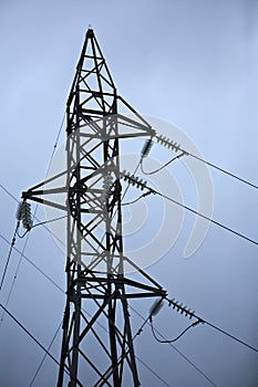 Electric high voltage post with sky background