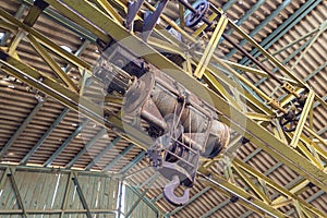 Electric hoist hanging from the ceiling of an industrial building in the mines of Portman, Murcia, Spain