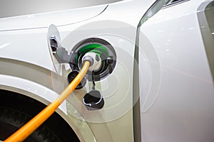 Electric hybrid car plugin in to charger to charging electric power to battery to reserve energy