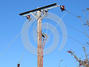 Electric infrastructure post carrying voltage to homes