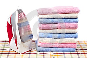 Electric iron and towels stacked