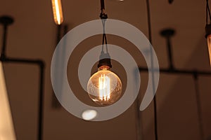 A electric lamp lighting . modern and vintage style , interior ceiling hanging light bulb decorate at room