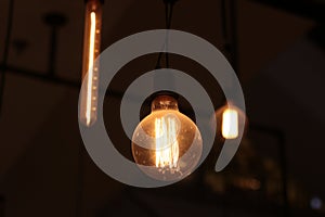 A electric lamp lighting . modern and vintage style , interior ceiling hanging light bulb decorate at room