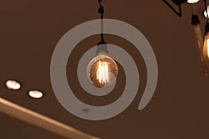 A electric lamp lighting . modern and vintage style , interior ceiling hanging light bulb decorate at room