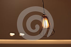 A electric lamp lighting . modern and vintage style , interior ceiling hanging light bulb decorate at room