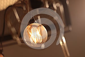 A electric lamp lighting . modern and vintage style , interior ceiling hanging light bulb decorate at room