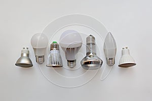 Electric lamps in a row on white background