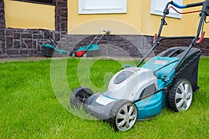 An electric lawn mower in the house backyard