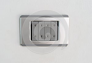 An electric light switch against white wall