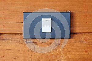 Electric light switch on old wood wall
