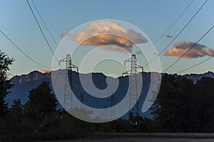 Electric lines at dusk with mountains in background