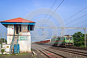 Electric loco powered parcel train , passing past the old signal cabin at Pulgaon