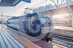 Electric locomotive stands by the platform at morning time