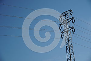 Electric mast or pillar with wires for transportation of electricity for end users.