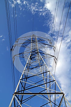 Electric mast pole tower pilot on blue cloud sky