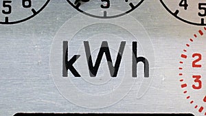 Electric meter close-up of kWh symbol, static shot.