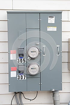 Electric Meters For Apartments are located on the wall outside the building. Close-up