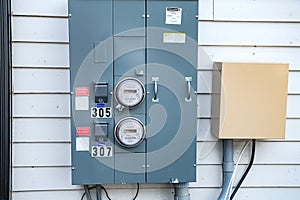 Electric Meters For Apartments are located on the wall outside the building. Close-up