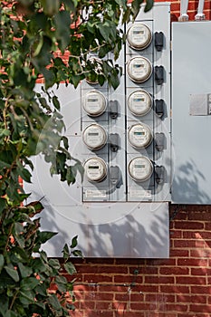 Electric Meters For Apartments are located on the wall outside the building. Close-up