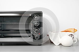 Electric mini oven on gray background studio shot close up