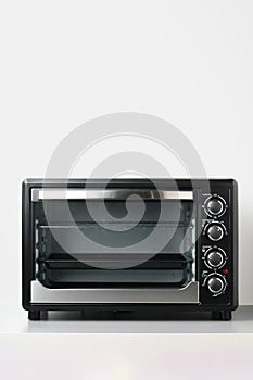 Electric mini oven on gray background studio shot close up