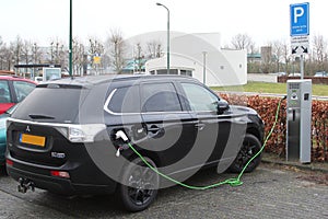 Modern electric plug car Mitsubishi Outlander charges new electric energy, Netherlands