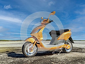 Electric moped parked outdoors against blue sky