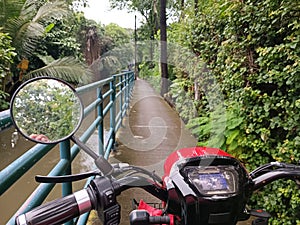 Electric motorbikes are running parallel to the drainage ditches in the capital.