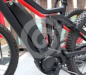 Electric mountain bike or e bicycle. Details of  motor, battery and suspension shock absorber.