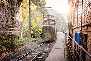 Electric narrow-gauge locomotive with the coal loaded freight train. photo