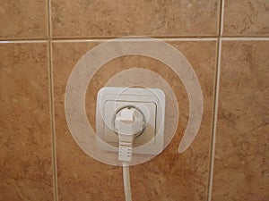 Electric outlet with cable plugged